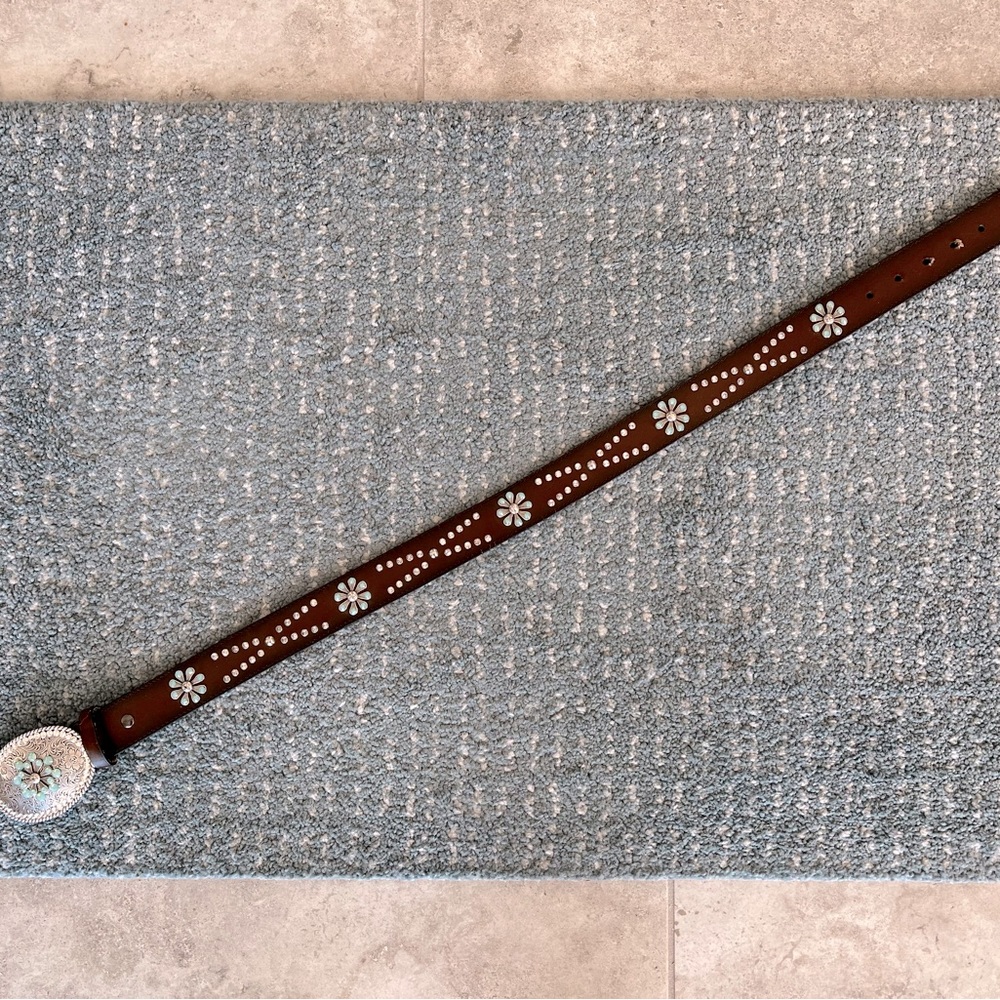 Dark brown leather belt in Western style. Silver buckle with turquoise stones